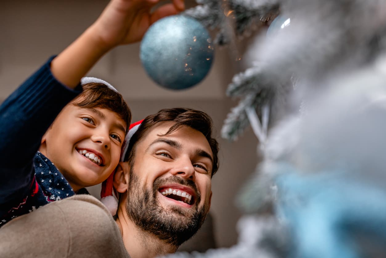 A man and a child decorating Christmas tree, Egypt Christmas Vacation