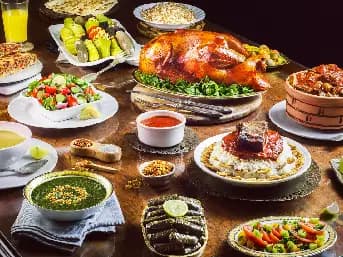  Variety of traditional Egyptian food dishes including koshari, falafel, mahshi, hawawshi, and fresh pita bread.